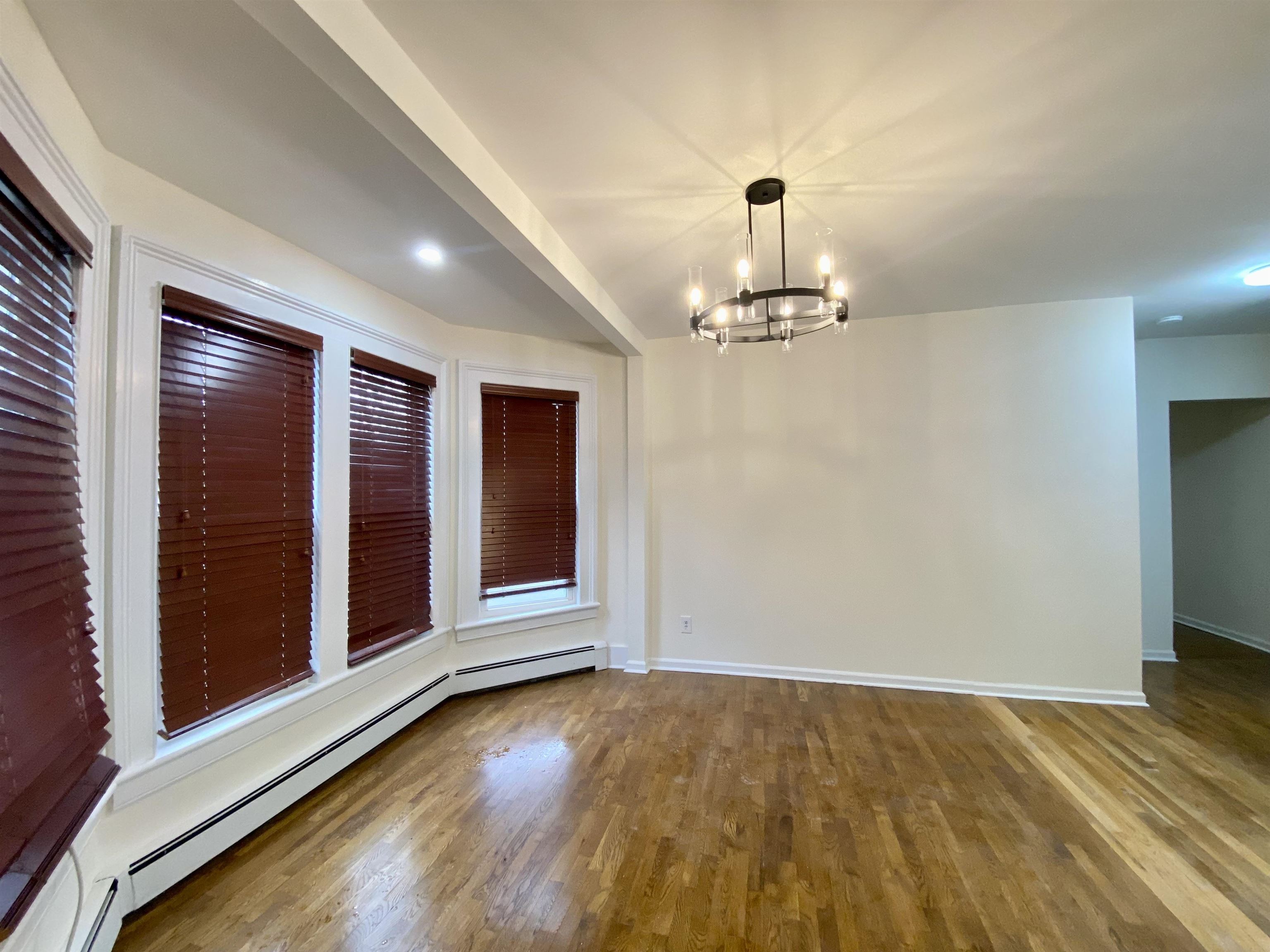 228 Tenafly Road, Unit 1 Tenafly, NJ 07670 - Photo 4 of 10 wooden floor in an empty room with a window