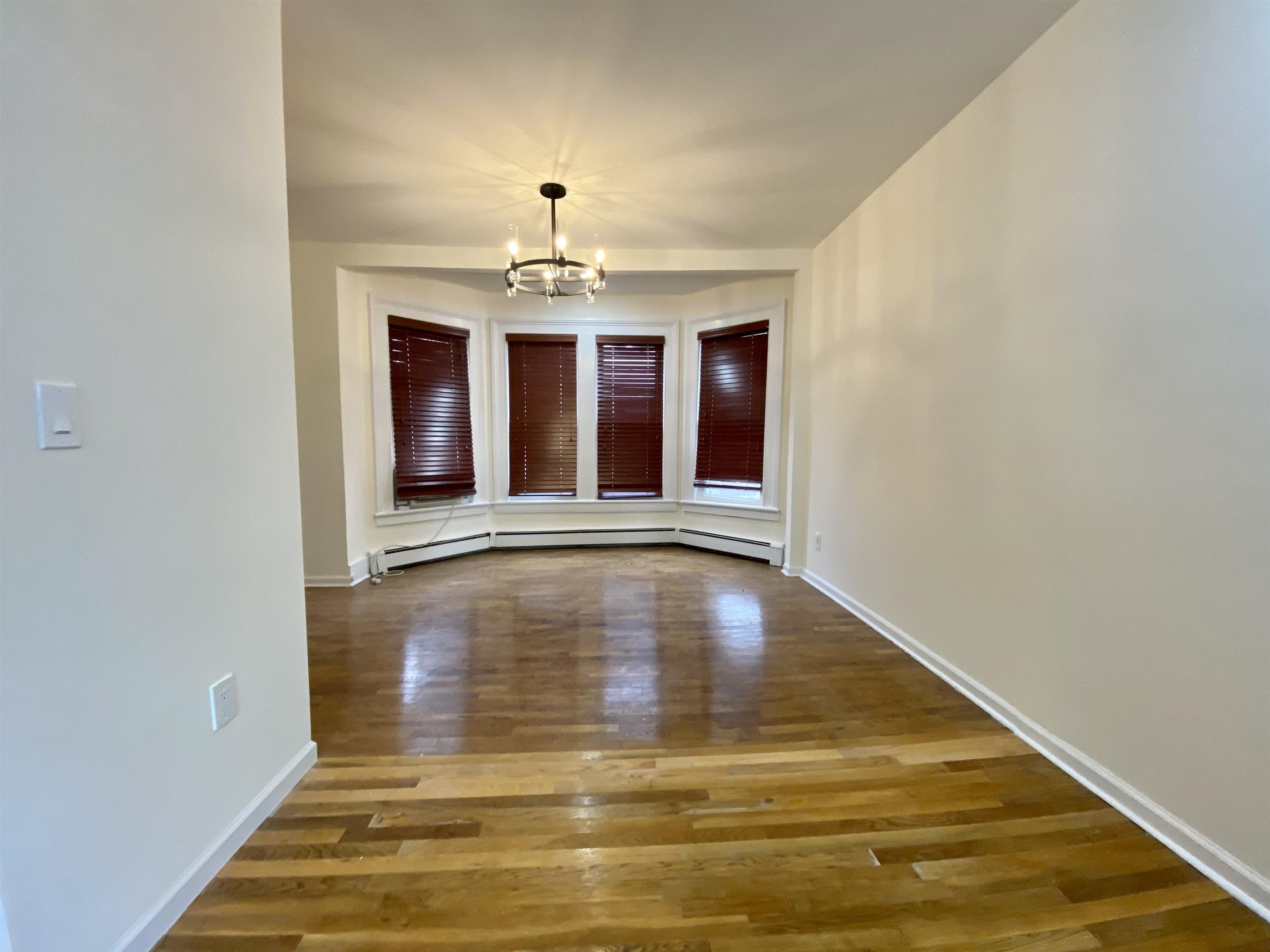 228 Tenafly Road, Unit 1 Tenafly, NJ 07670 - Photo 6 of 10 a view of an empty room with window and chandelier