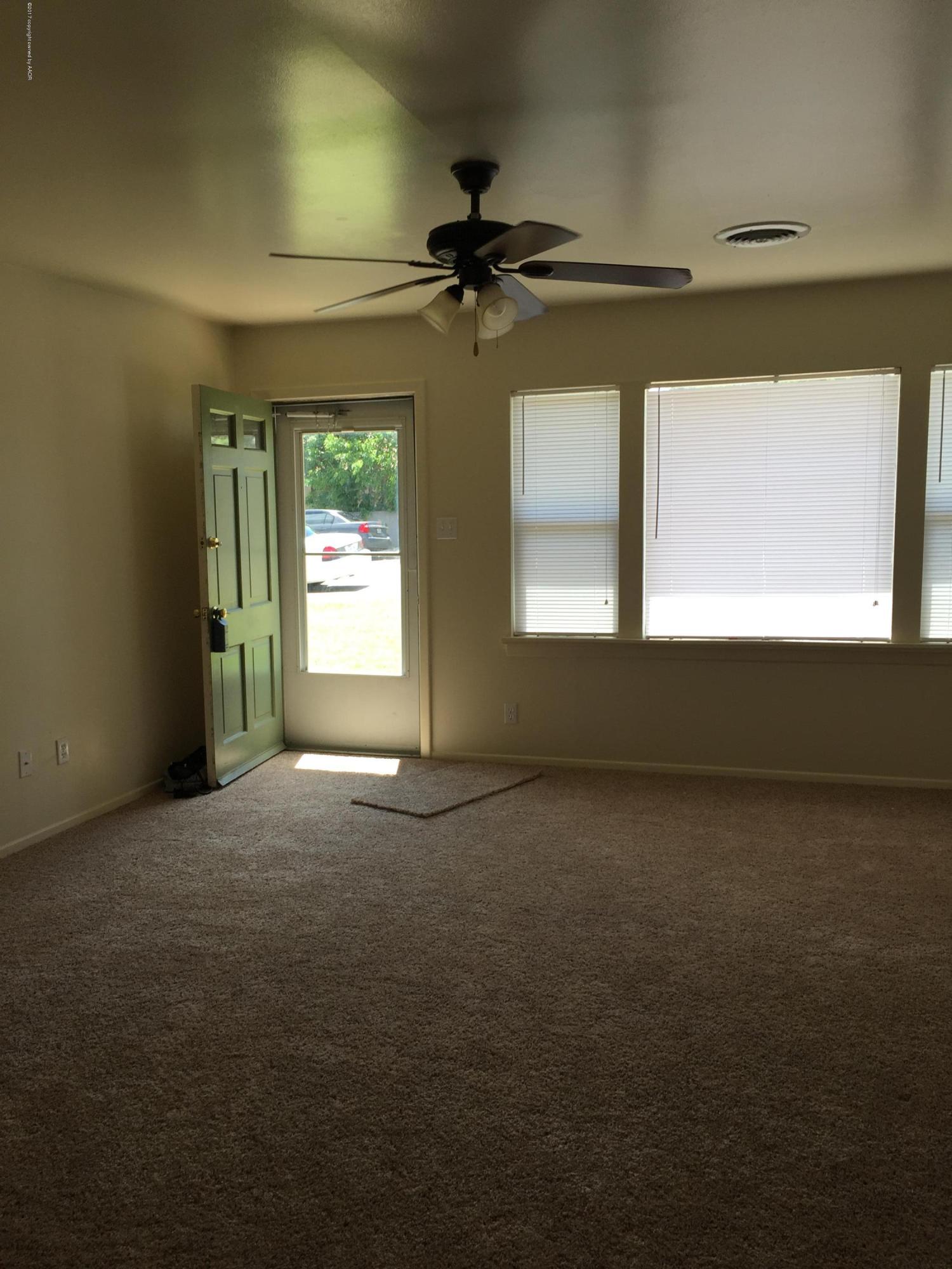 2402 Walnut Street Amarillo, TX 79107 - Photo 5 of 17 a view of an empty room with a window
