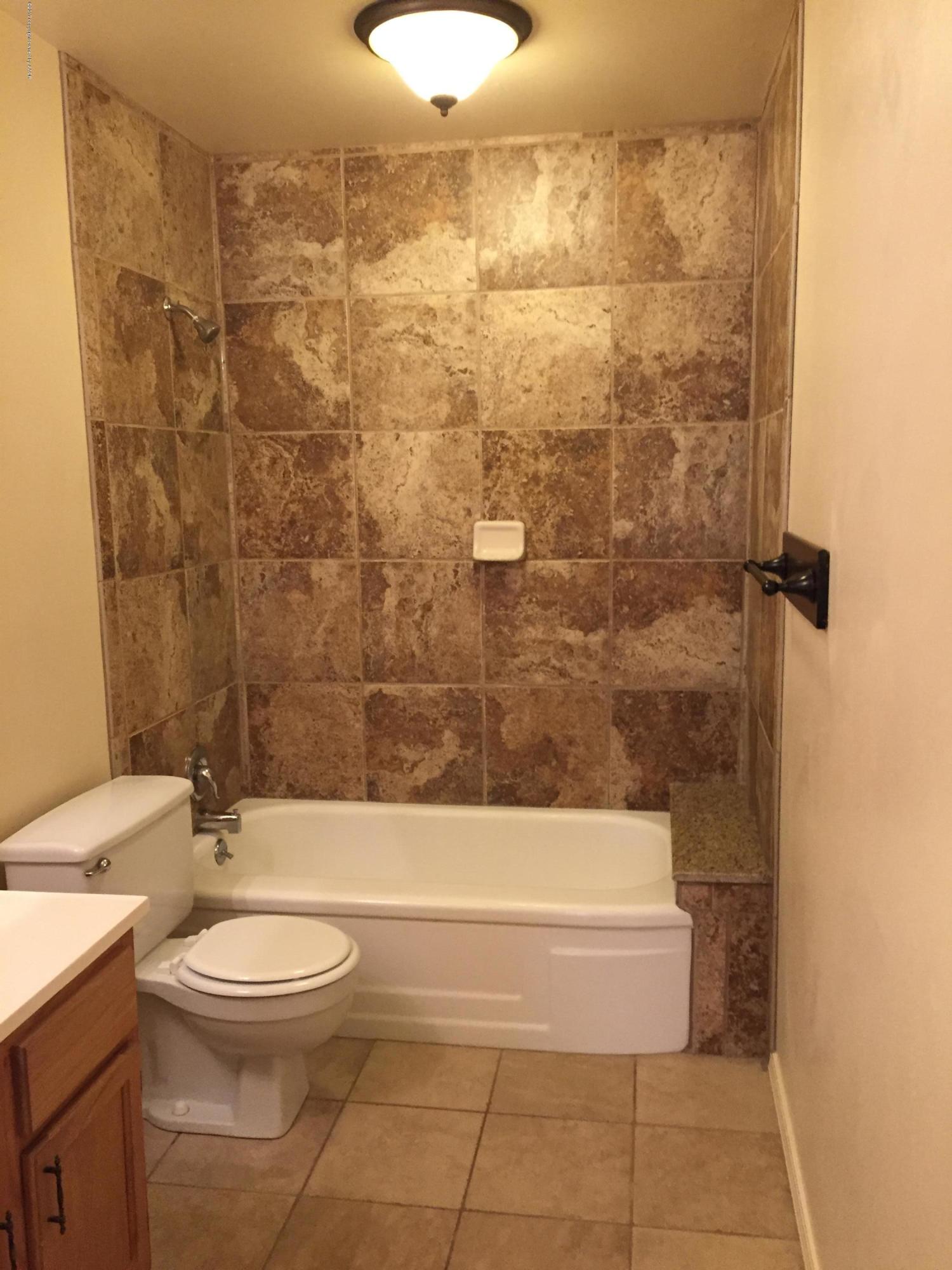 2402 Walnut Street Amarillo, TX 79107 - Photo 10 of 17 a bathroom with a toilet a sink and bathtub