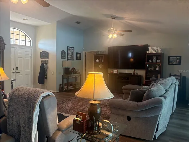 a living room with furniture and wooden floor