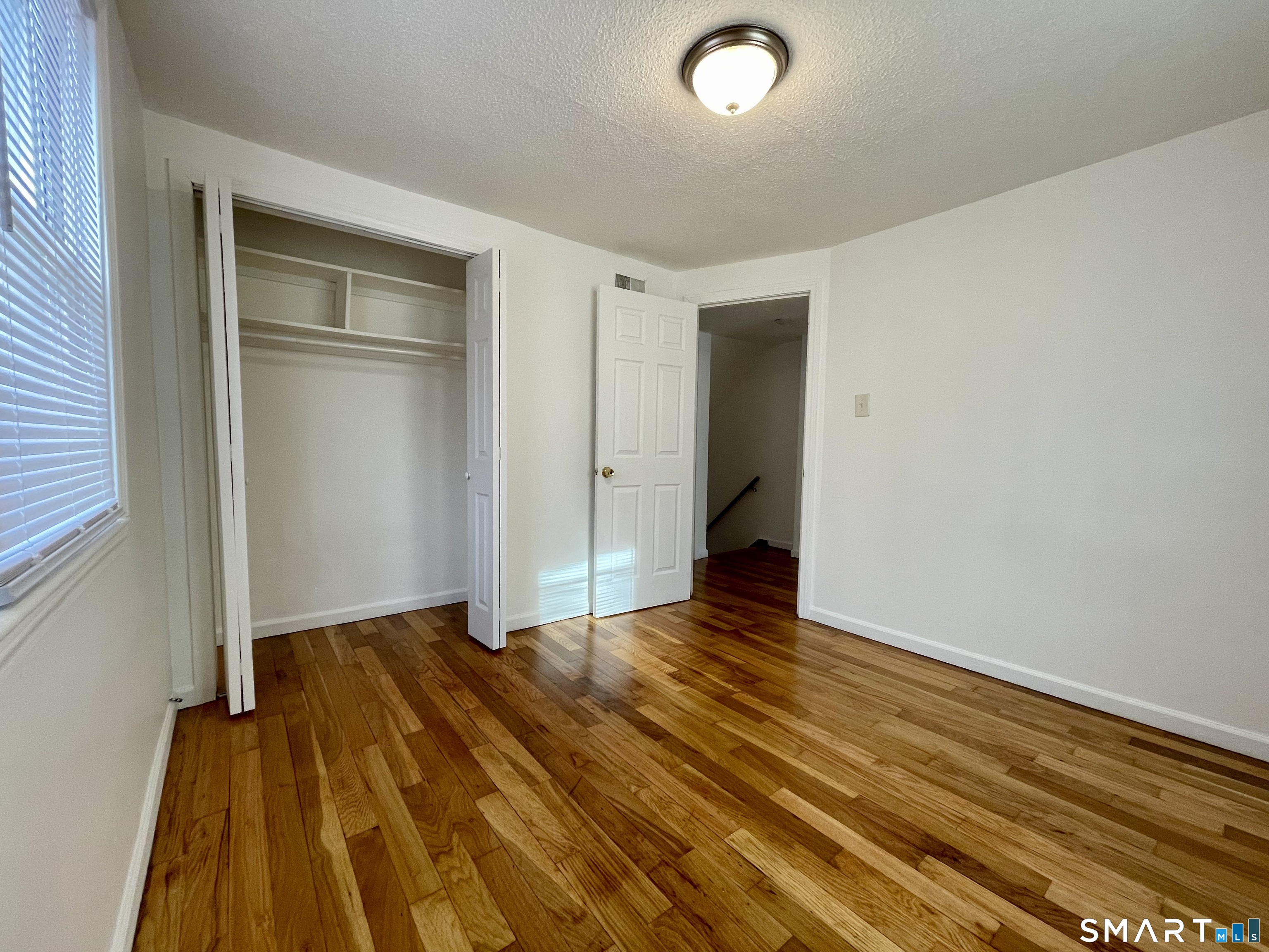 35 Baltic Street Hartford, CT 06112 - Photo 12 of 18 a view of an empty room with closet and wooden floor