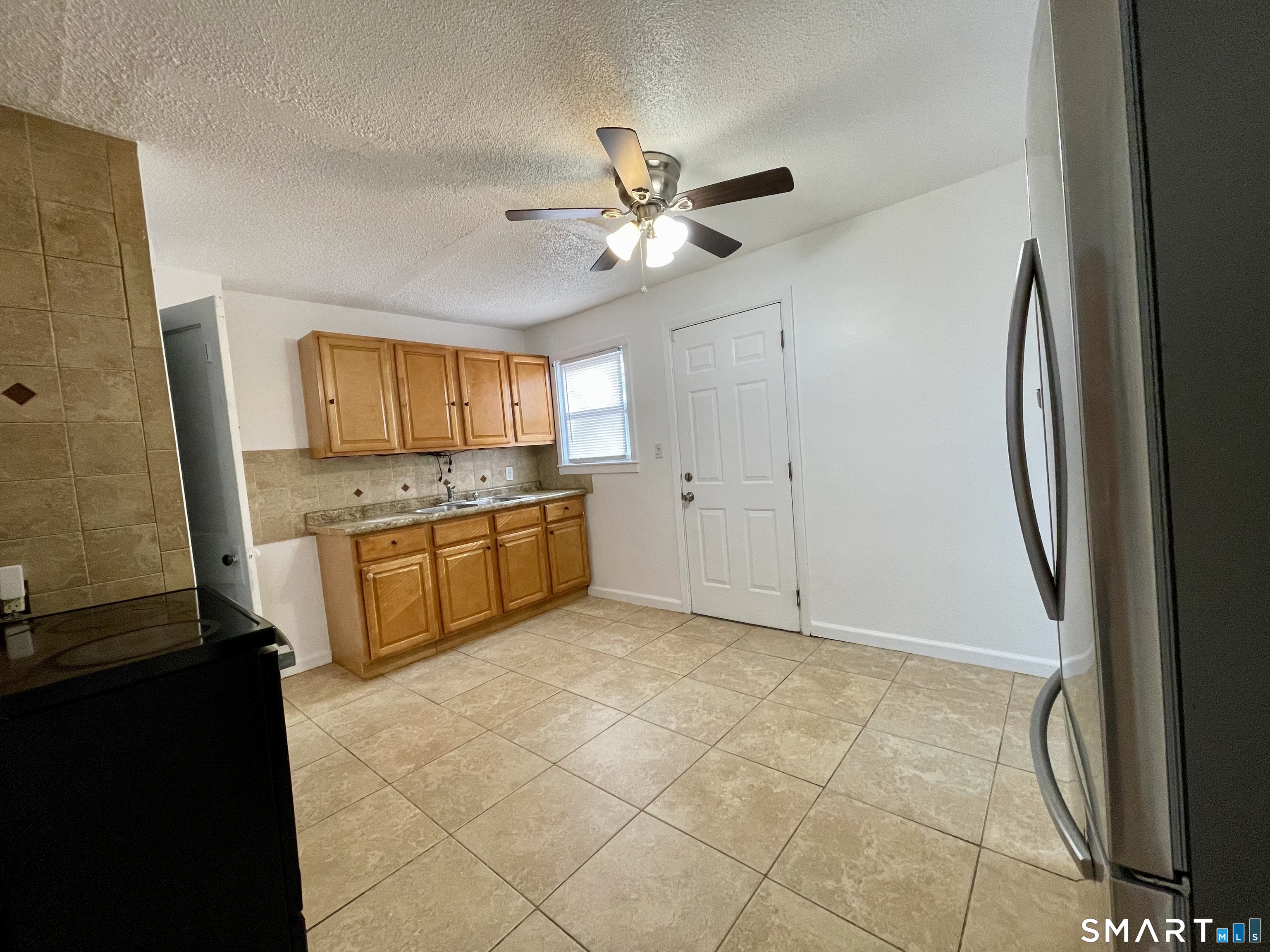 35 Baltic Street Hartford, CT 06112 - Photo 14 of 18 a kitchen with granite countertop a stove a sink and a refrigerator