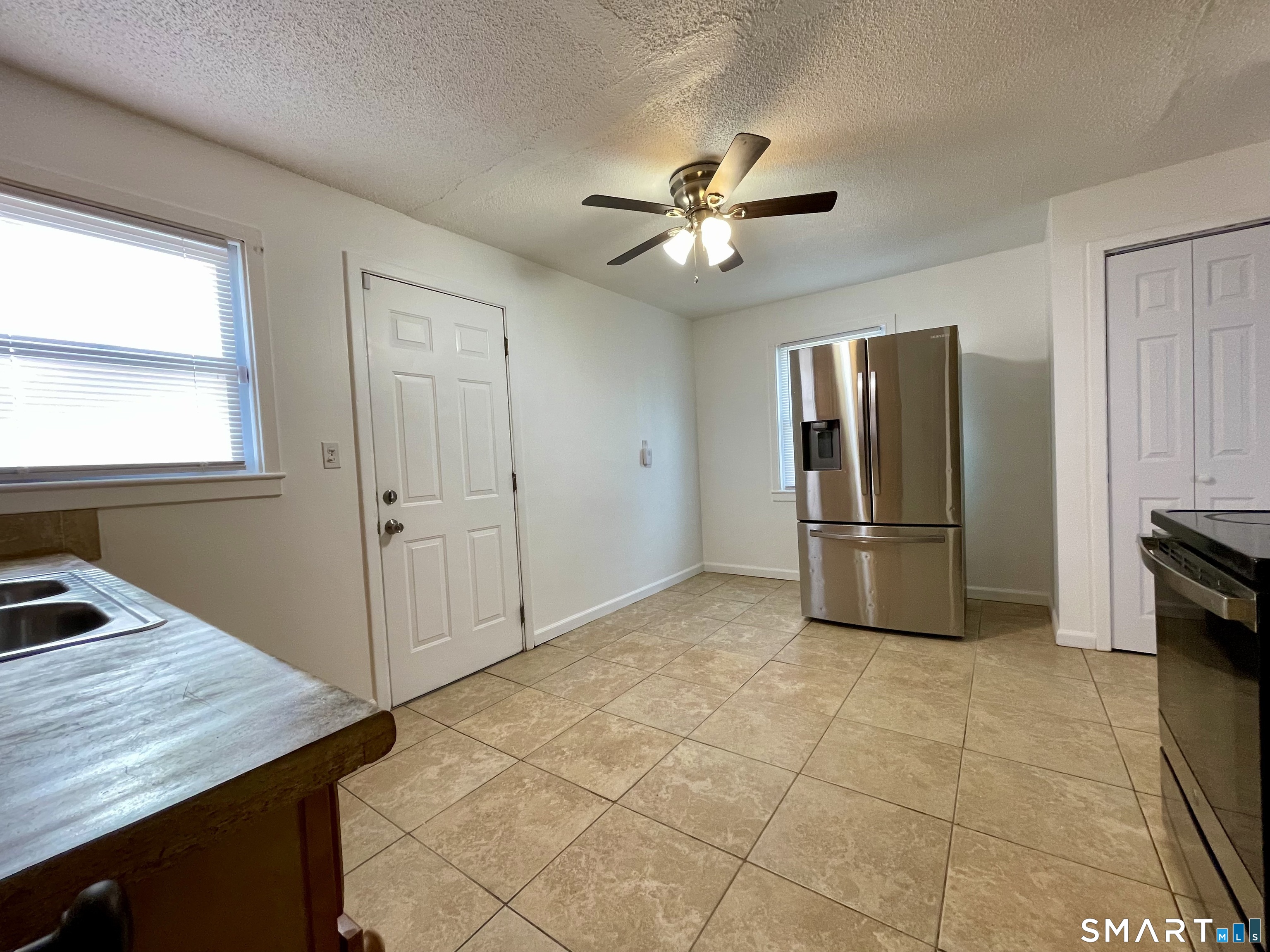 35 Baltic Street Hartford, CT 06112 - Photo 15 of 18 a kitchen with a refrigerator a sink and cabinets