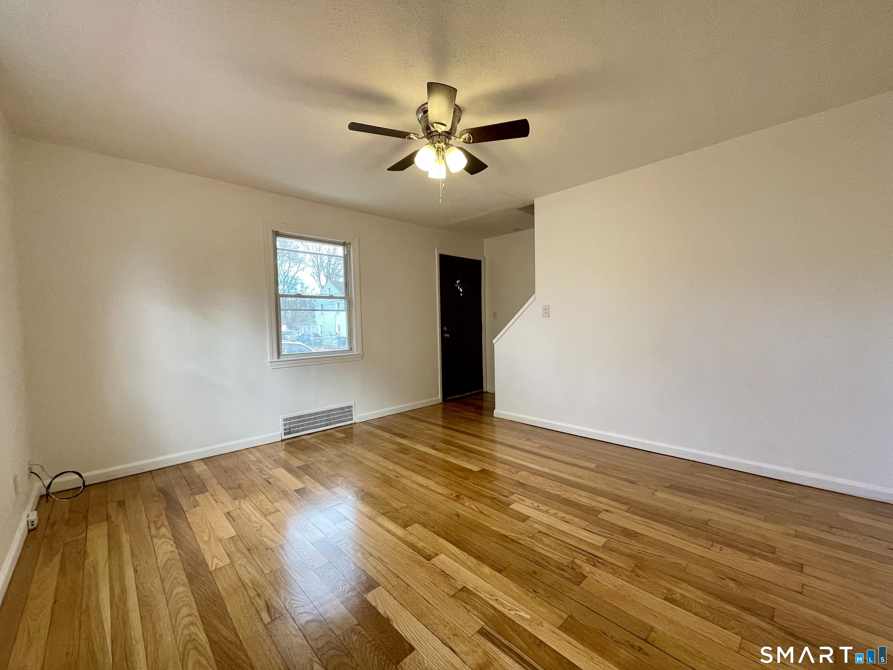 35 Baltic Street Hartford, CT 06112 - Photo 7 of 18 a view of an empty room with window and wooden floor