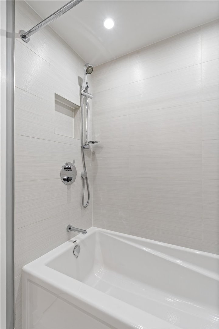 916 West Fletcher Street, Unit C Chicago, IL 60657 - Photo 11 of 16 a bathroom with a tub and a shower