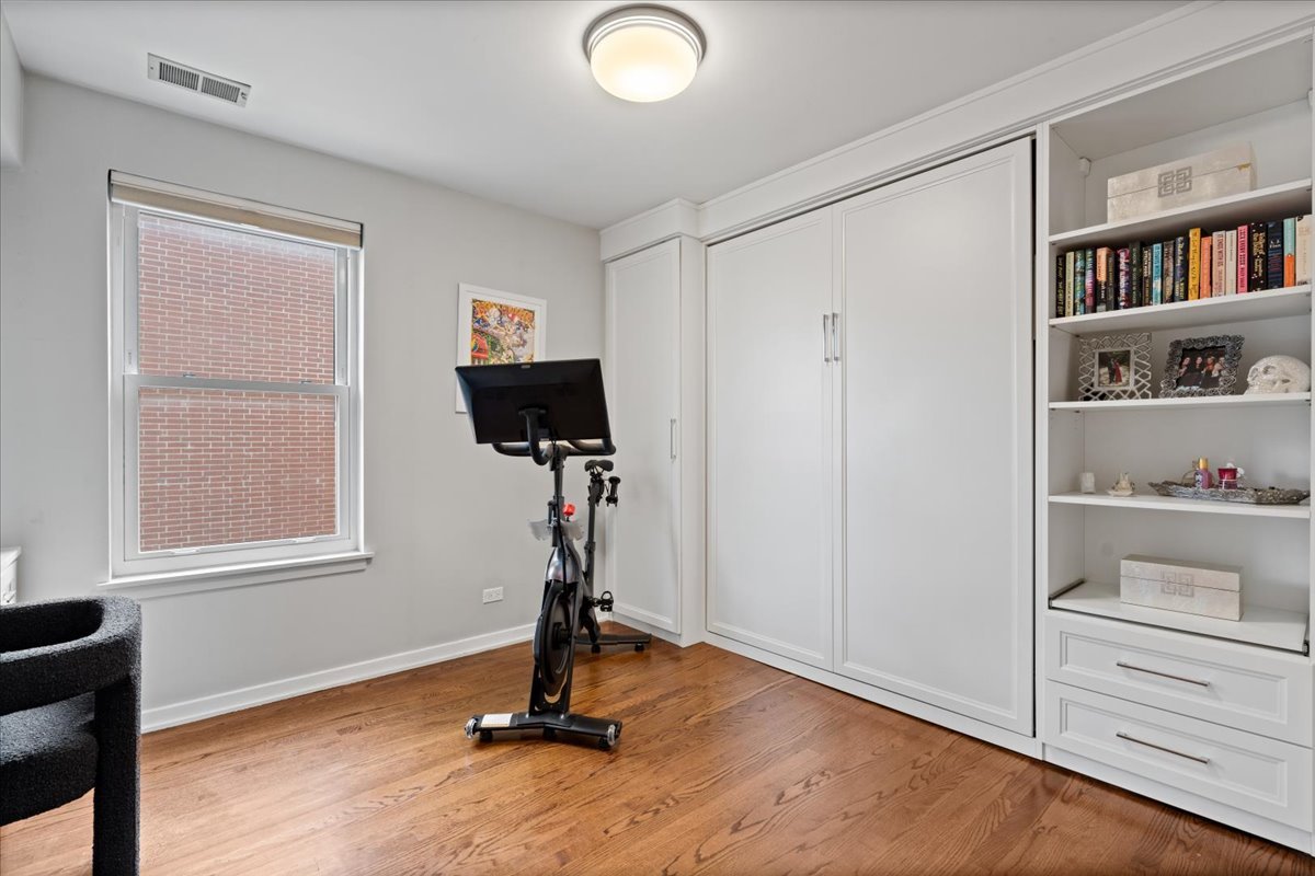 916 West Fletcher Street, Unit C Chicago, IL 60657 - Photo 12 of 16 a view of room with window and wooden floor