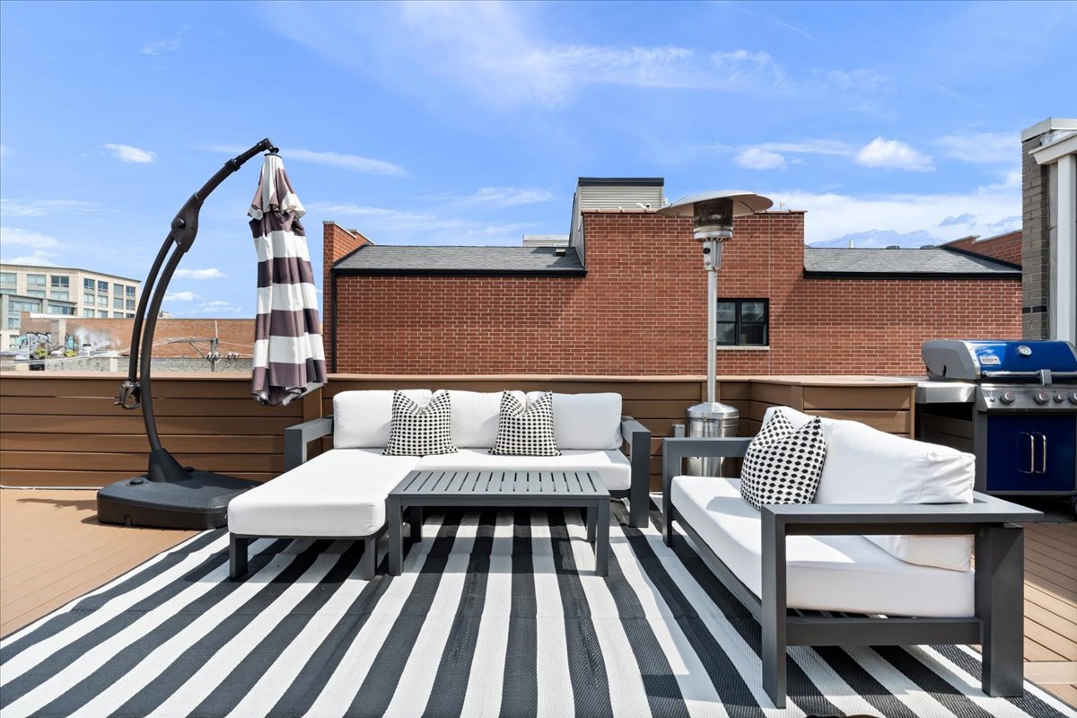 916 West Fletcher Street, Unit C Chicago, IL 60657 - Photo 16 of 16 a roof deck with a couch and chairs
