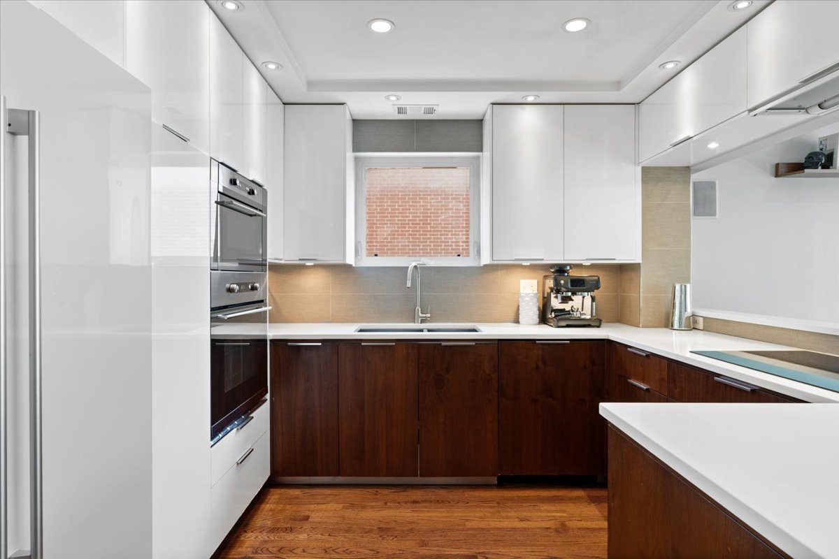 916 West Fletcher Street, Unit C Chicago, IL 60657 - Photo 5 of 16 a kitchen with stainless steel appliances granite countertop a sink stove and refrigerator