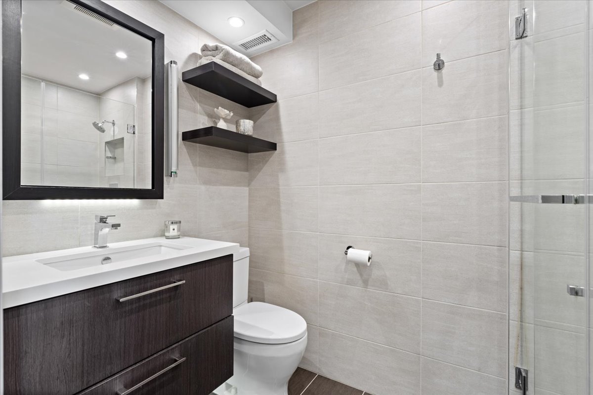 916 West Fletcher Street, Unit C Chicago, IL 60657 - Photo 8 of 16 a bathroom with a toilet sink and mirror