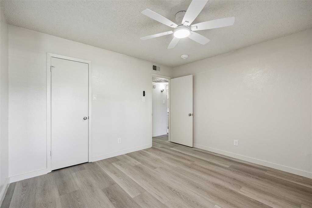 11480 Audelia Road, Unit 136 Dallas, TX 75243 - Photo 26 of 29 Room featuring wood-finish flooring and a ceiling fan with integrated lighting