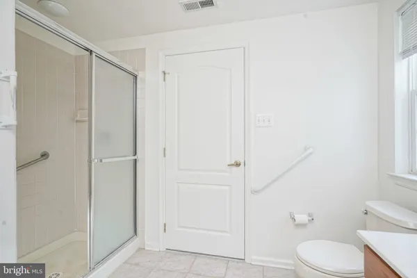 a bathroom with a toilet and a shower