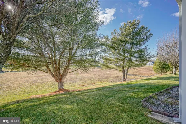 a view of a house with backyard and porch