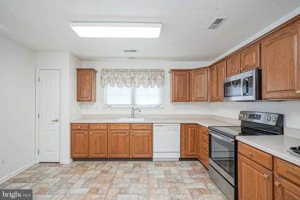a kitchen with stainless steel appliances granite countertop a sink and cabinets