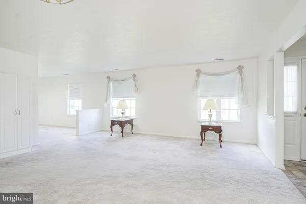a view of a livingroom with a chair and window