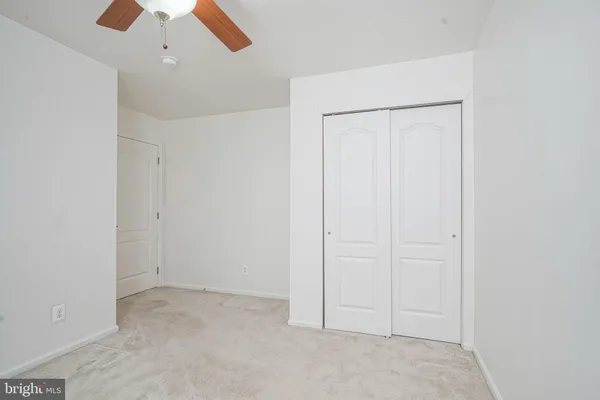an empty room with a ceiling fan