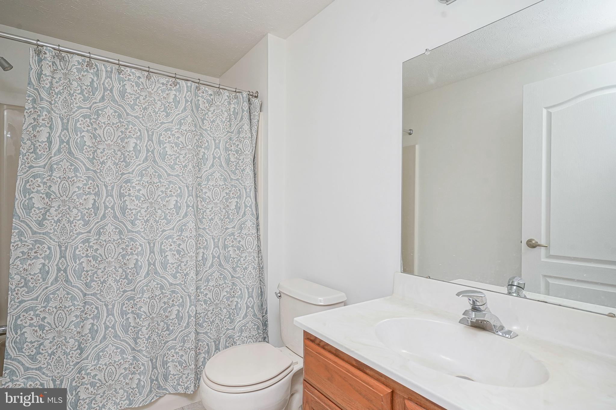 16 Magnolia Lane Sewell, NJ 08080 - Photo 10 of 21 a bathroom with a sink a toilet and shower curtain