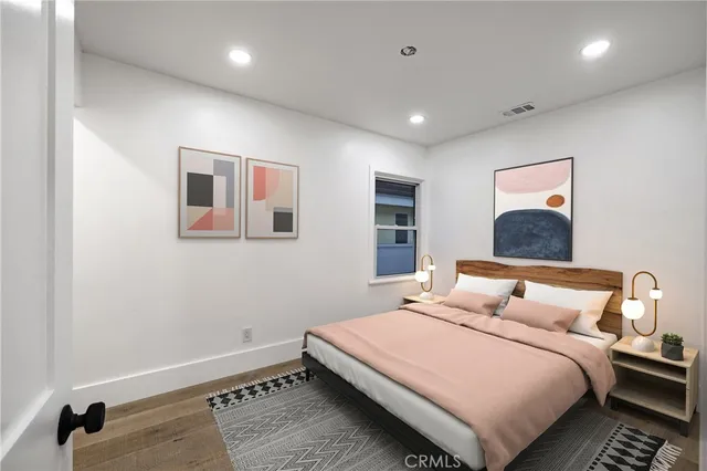 a bedroom with a large bed and a window