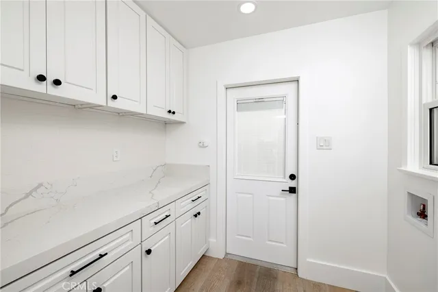 a kitchen with white cabinets and white appliances
