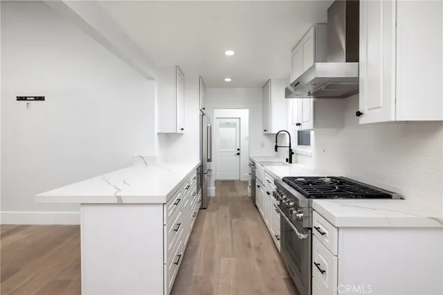 a kitchen that has a sink and a stove
