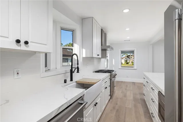 a kitchen with sink a refrigerator and stove