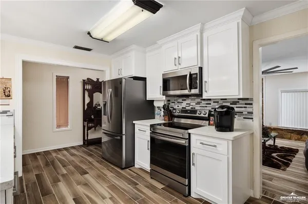 a kitchen with a refrigerator stove and microwave