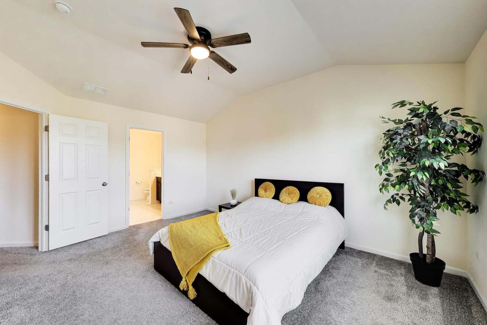 4152 Calder Lane Aurora, IL 60504 - Photo 14 of 30 a bed sitting in a bedroom next to a potted plant on a dresser