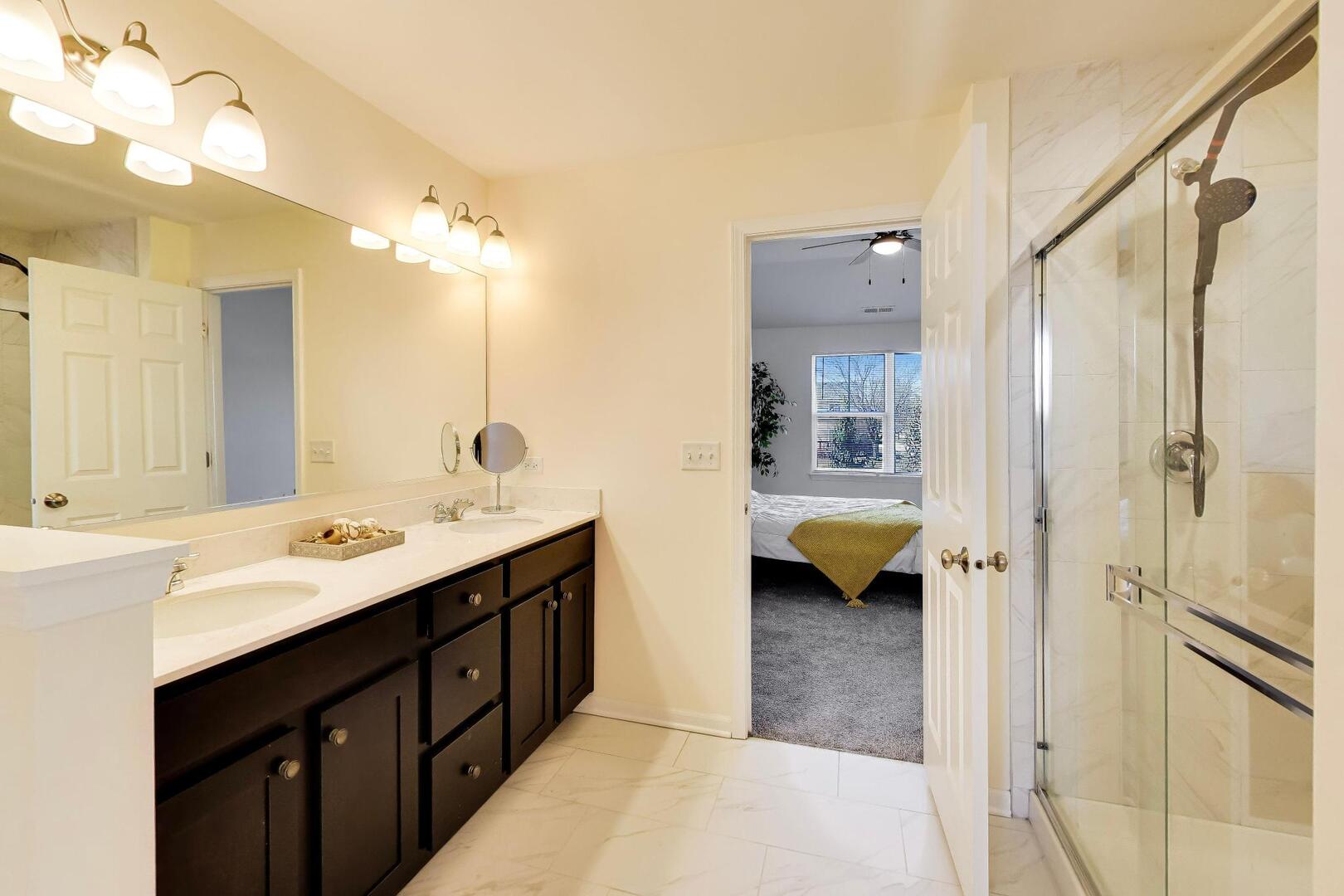 4152 Calder Lane Aurora, IL 60504 - Photo 16 of 30 a en suite bathroom with a double vanity sink a mirror and shower