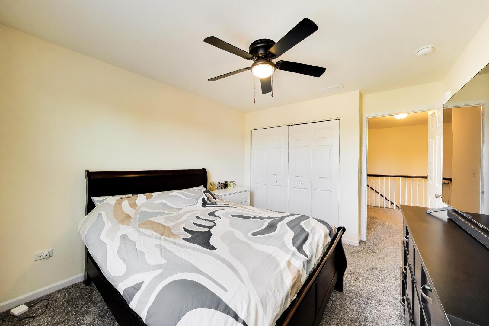4152 Calder Lane Aurora, IL 60504 - Photo 20 of 30 a bedroom with a bed and wooden floor