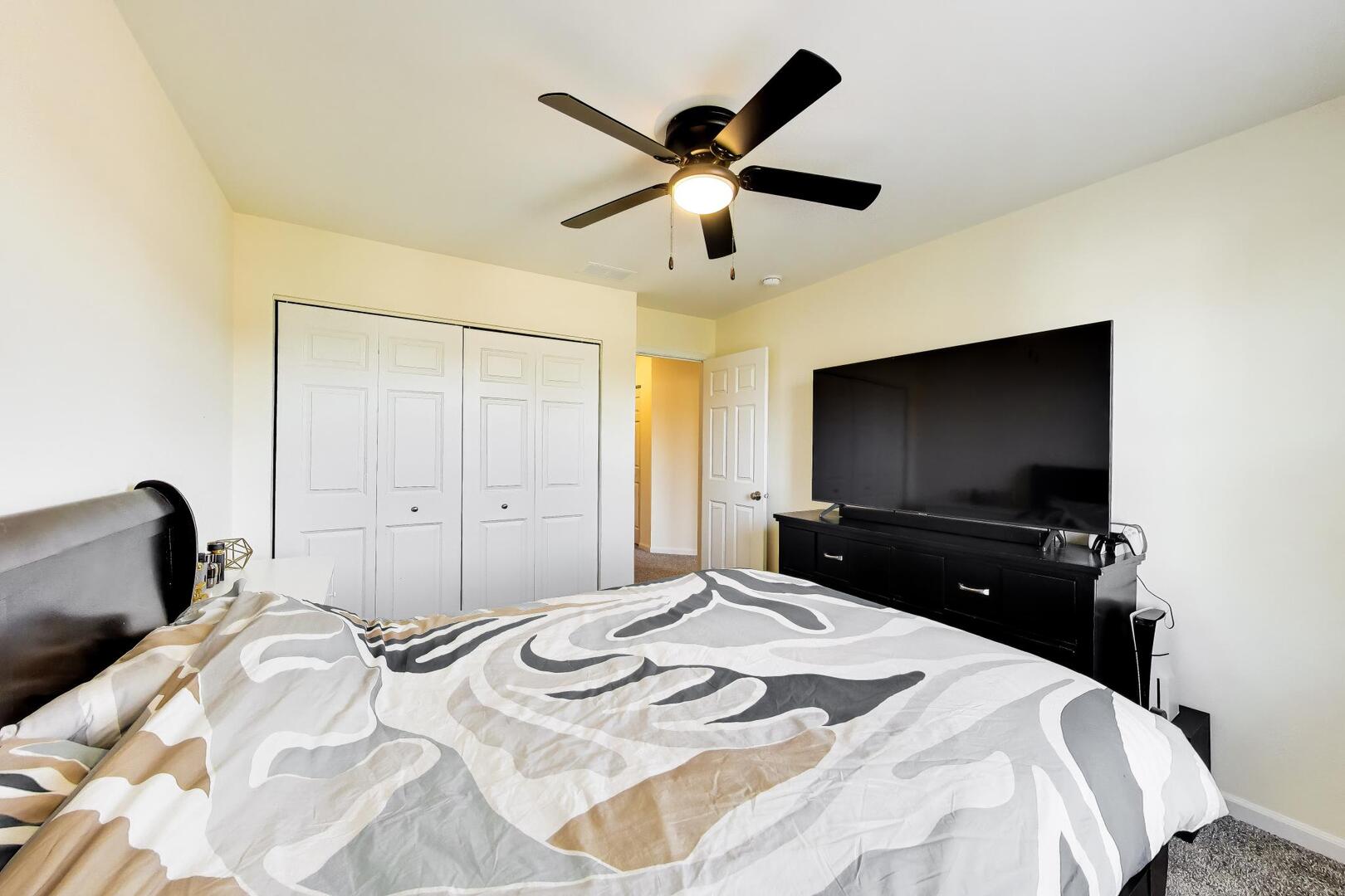 4152 Calder Lane Aurora, IL 60504 - Photo 21 of 30 a bedroom with a bed and a flat screen tv