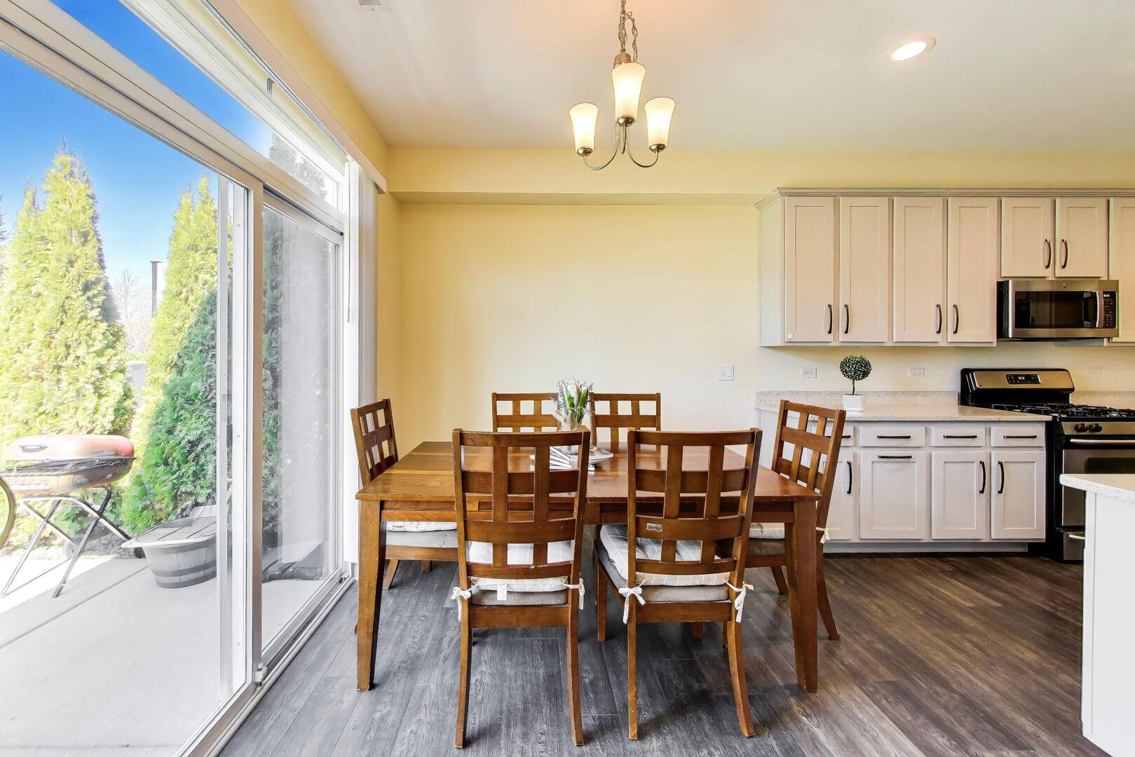 4152 Calder Lane Aurora, IL 60504 - Photo 10 of 30 a view of a dining room with furniture a chandelier and wooden floor