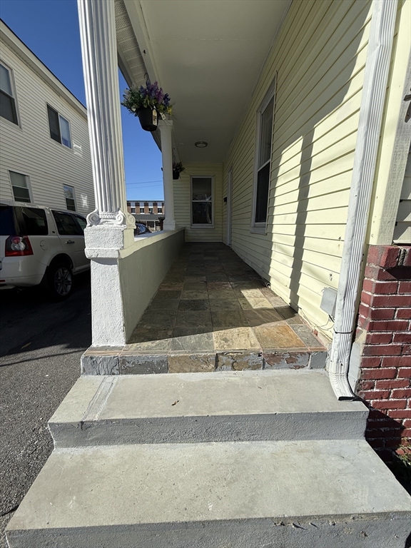 213 Concord Street, Unit 1 Lowell, MA 01852 - Photo 2 of 12 a view of entryway and kitchen