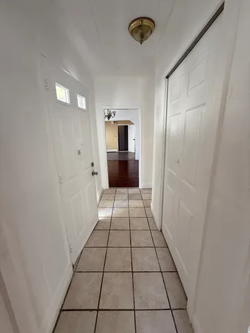 a view of a hallway view of a kitchen