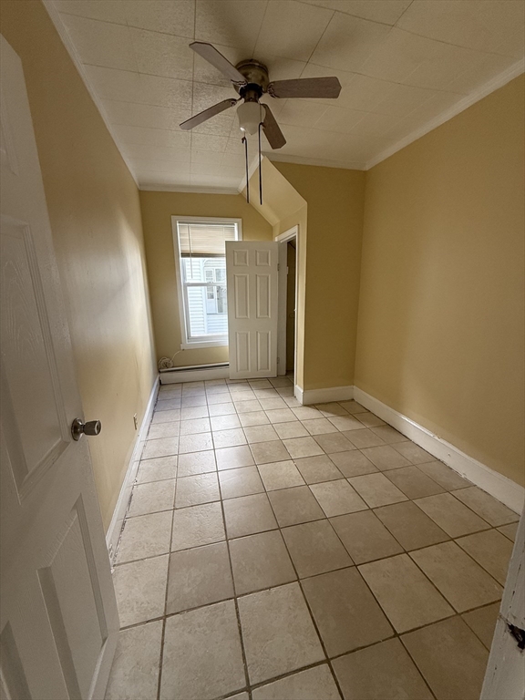 213 Concord Street, Unit 1 Lowell, MA 01852 - Photo 4 of 12 a view of a livingroom with a chandelier fan and windows