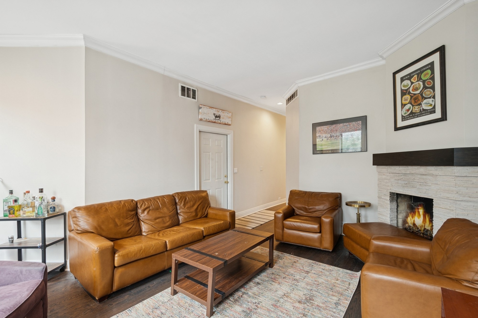 1302 North Cleveland Avenue, Unit 2 Chicago, IL 60610 - Photo 2 of 12 a living room with furniture a couch and a fireplace