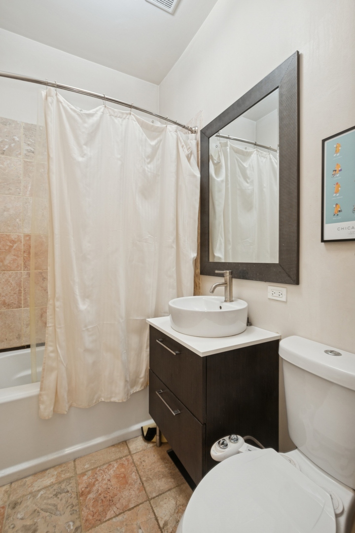 1302 North Cleveland Avenue, Unit 2 Chicago, IL 60610 - Photo 9 of 12 a bathroom with a sink and a mirror
