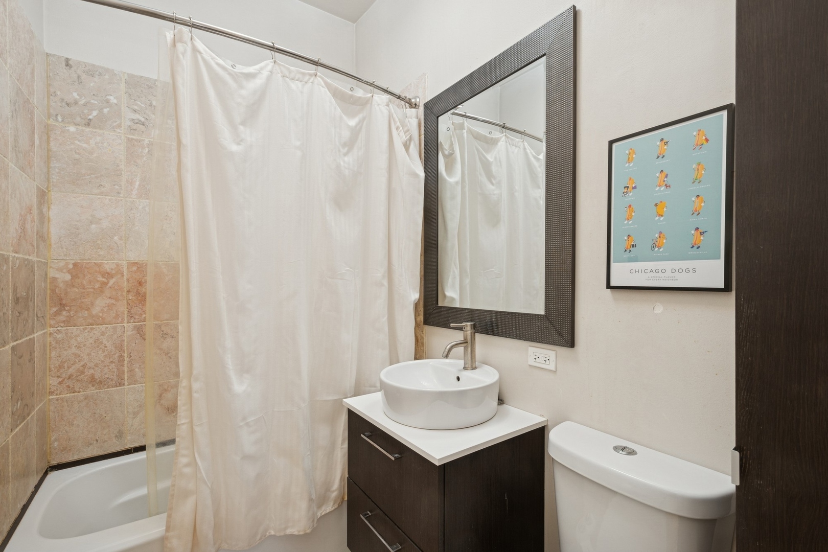 1302 North Cleveland Avenue, Unit 2 Chicago, IL 60610 - Photo 10 of 12 a bathroom with a sink a toilet and shower curtain