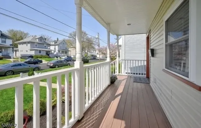 a view of a balcony with wooden floor