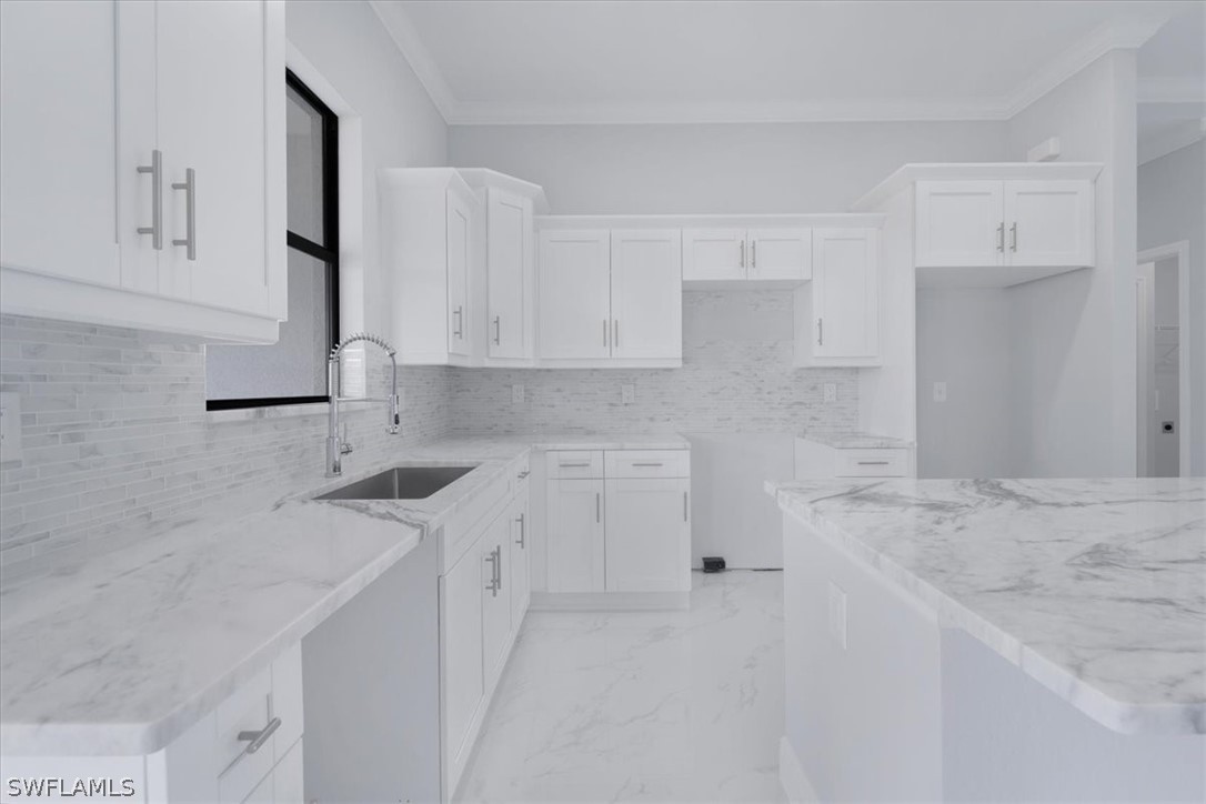 3915 20th Street Southwest Lehigh Acres, FL 33976 - Photo 12 of 50 a kitchen with a sink stove and cabinets