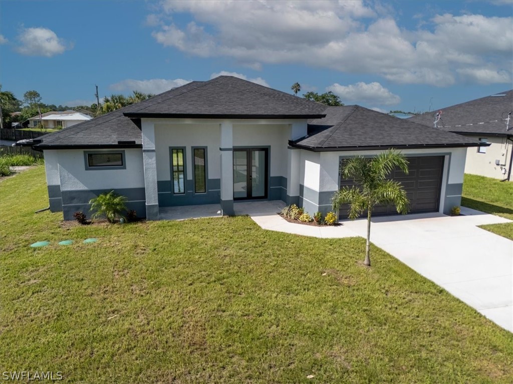 3915 20th Street Southwest Lehigh Acres, FL 33976 - Photo 2 of 50 a front view of a house with a yard