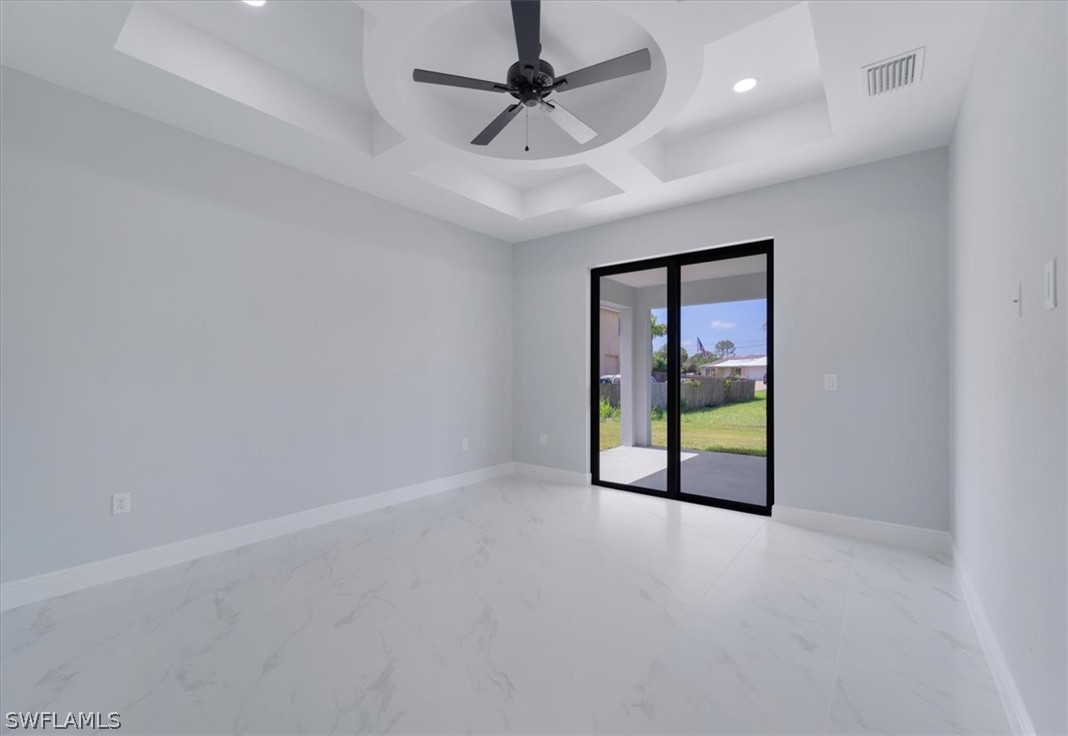 3915 20th Street Southwest Lehigh Acres, FL 33976 - Photo 24 of 50 en empty room with windows and ceiling fan
