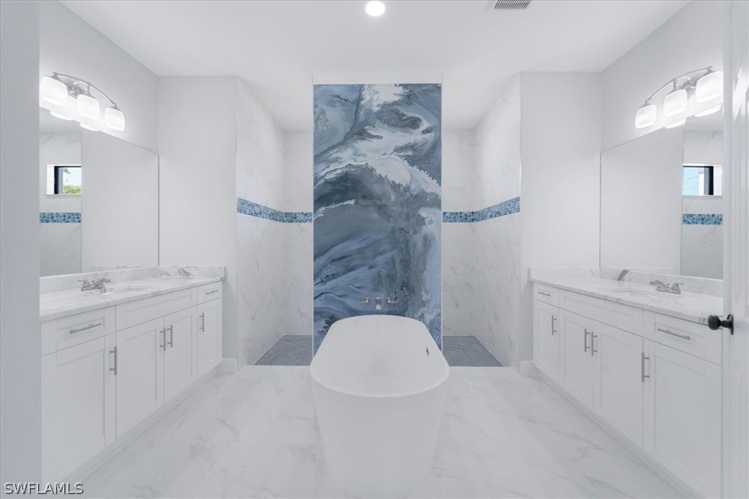 3915 20th Street Southwest Lehigh Acres, FL 33976 - Photo 27 of 50 a bathroom with a double vanity sink and mirror