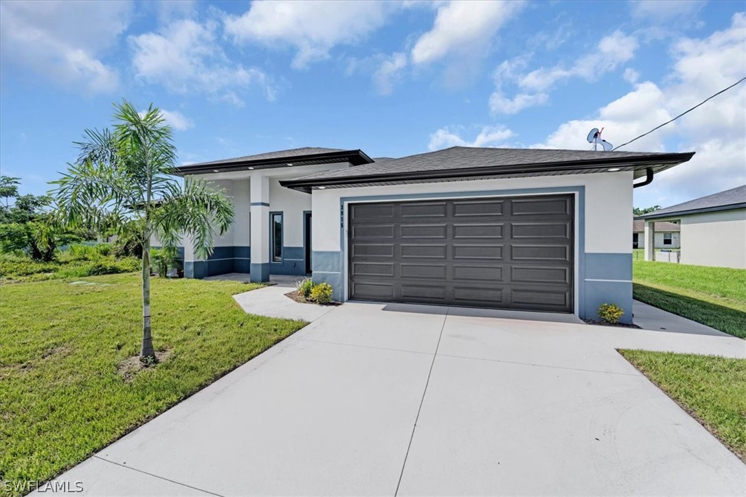 3915 20th Street Southwest Lehigh Acres, FL 33976 - Photo 3 of 50 a front view of a house with garden