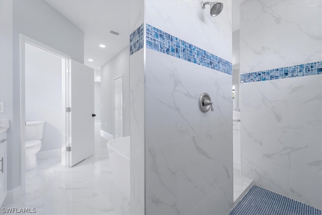 3915 20th Street Southwest Lehigh Acres, FL 33976 - Photo 31 of 50 a bathroom with a shower and a toilet