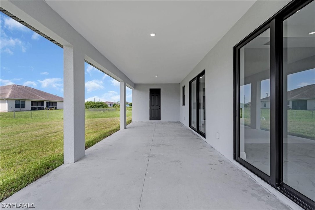 3915 20th Street Southwest Lehigh Acres, FL 33976 - Photo 38 of 50 a view of a porch with floor to ceiling window and garden