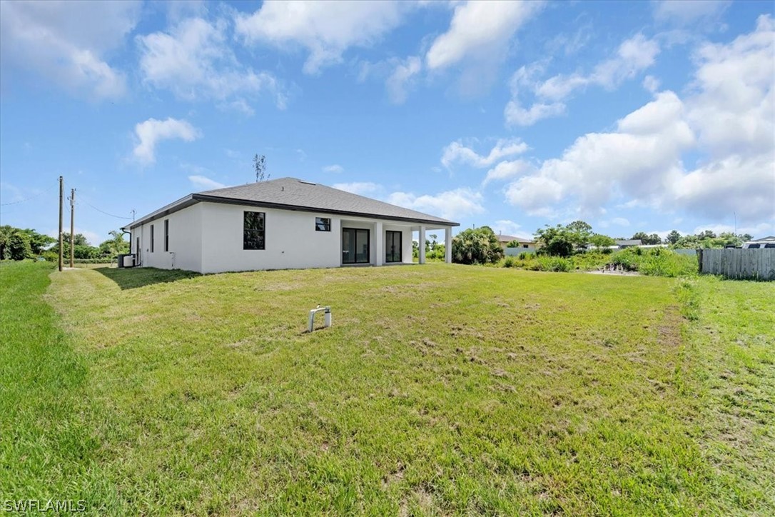 3915 20th Street Southwest Lehigh Acres, FL 33976 - Photo 39 of 50 a view of a house with a yard