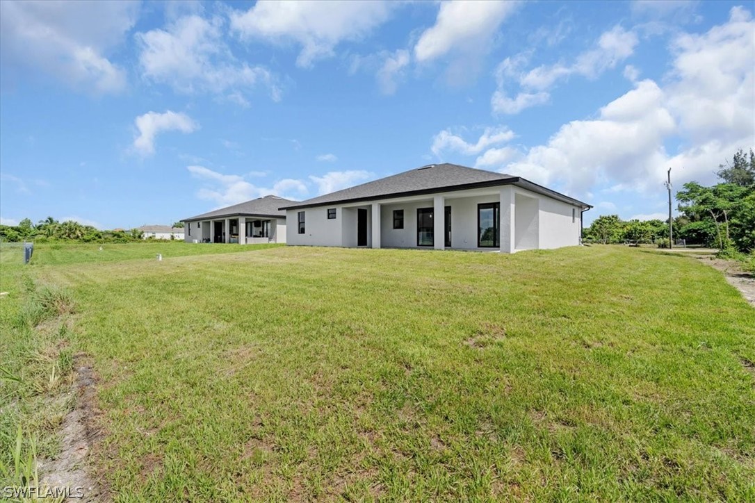 3915 20th Street Southwest Lehigh Acres, FL 33976 - Photo 41 of 50 a view of a house with a big yard and large trees