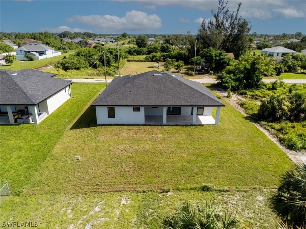 3915 20th Street Southwest Lehigh Acres, FL 33976 - Photo 42 of 50 a aerial view of a house with a swimming pool and mountains