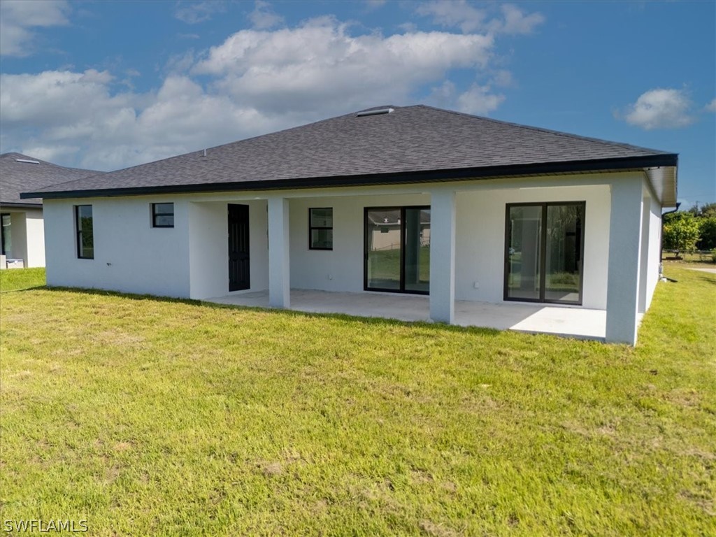 3915 20th Street Southwest Lehigh Acres, FL 33976 - Photo 43 of 50 a view of a house with a backyard