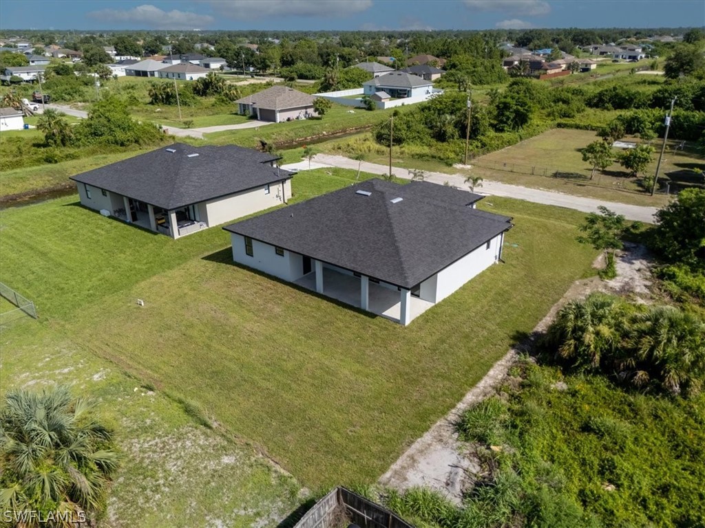 3915 20th Street Southwest Lehigh Acres, FL 33976 - Photo 45 of 50 an aerial view of residential houses with outdoor space and trees